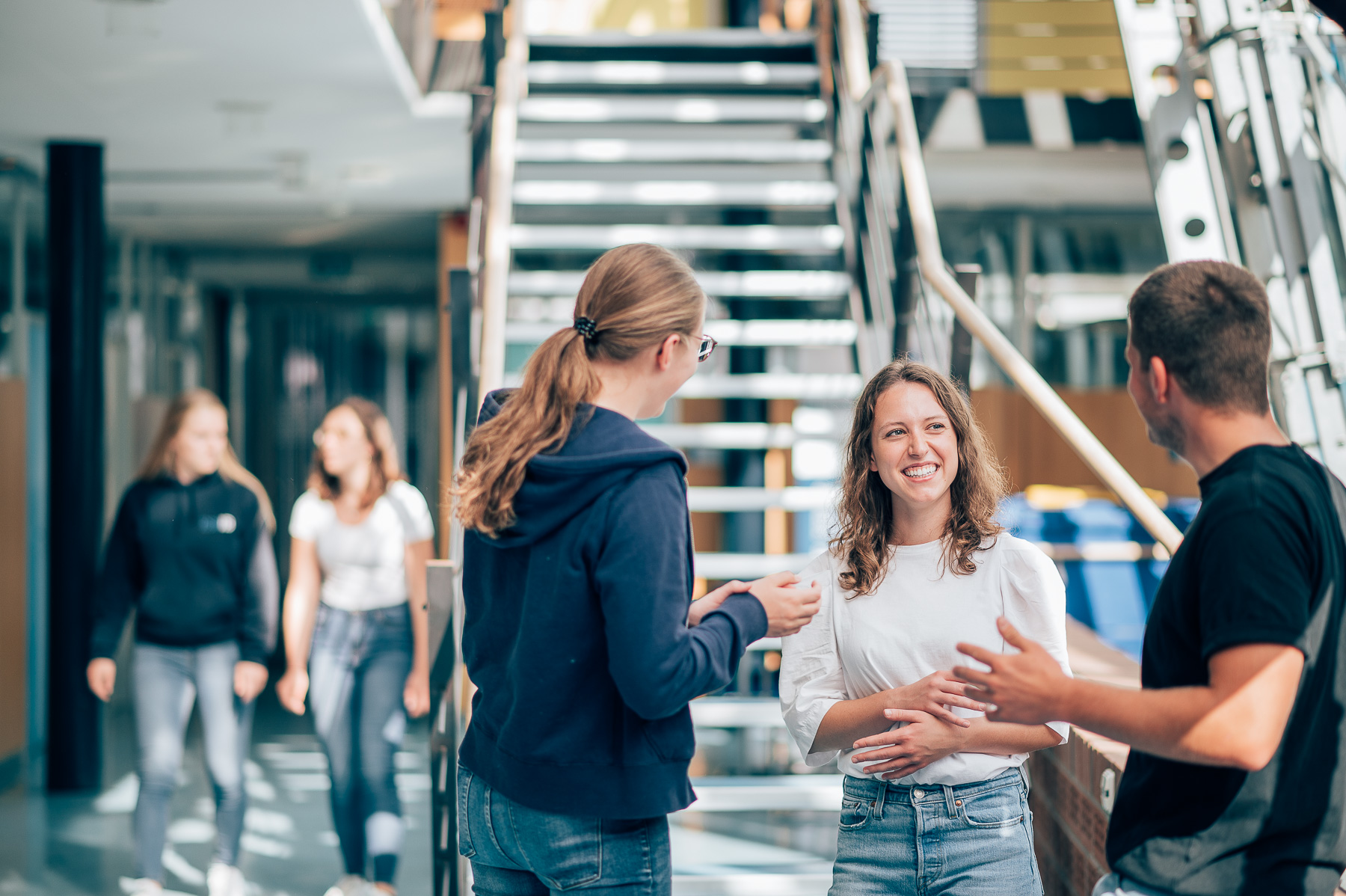 Sustainable production and business students at the ESB Business School chatting in the hallway.