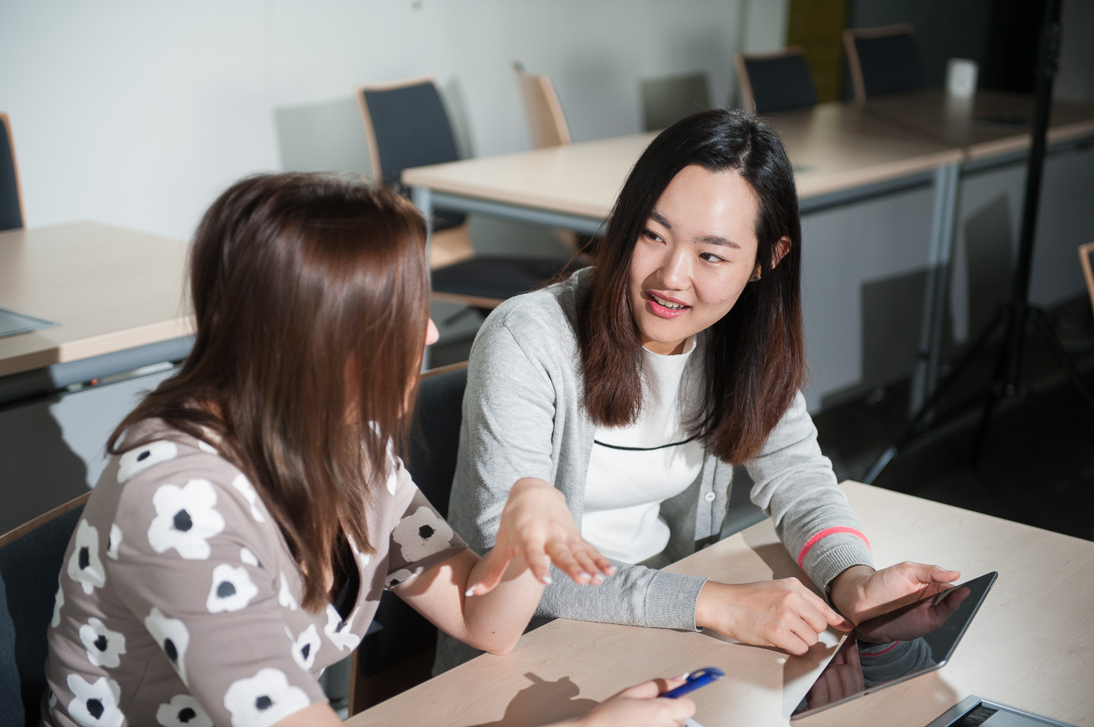 ESB Business School students chatting in a lecture room.