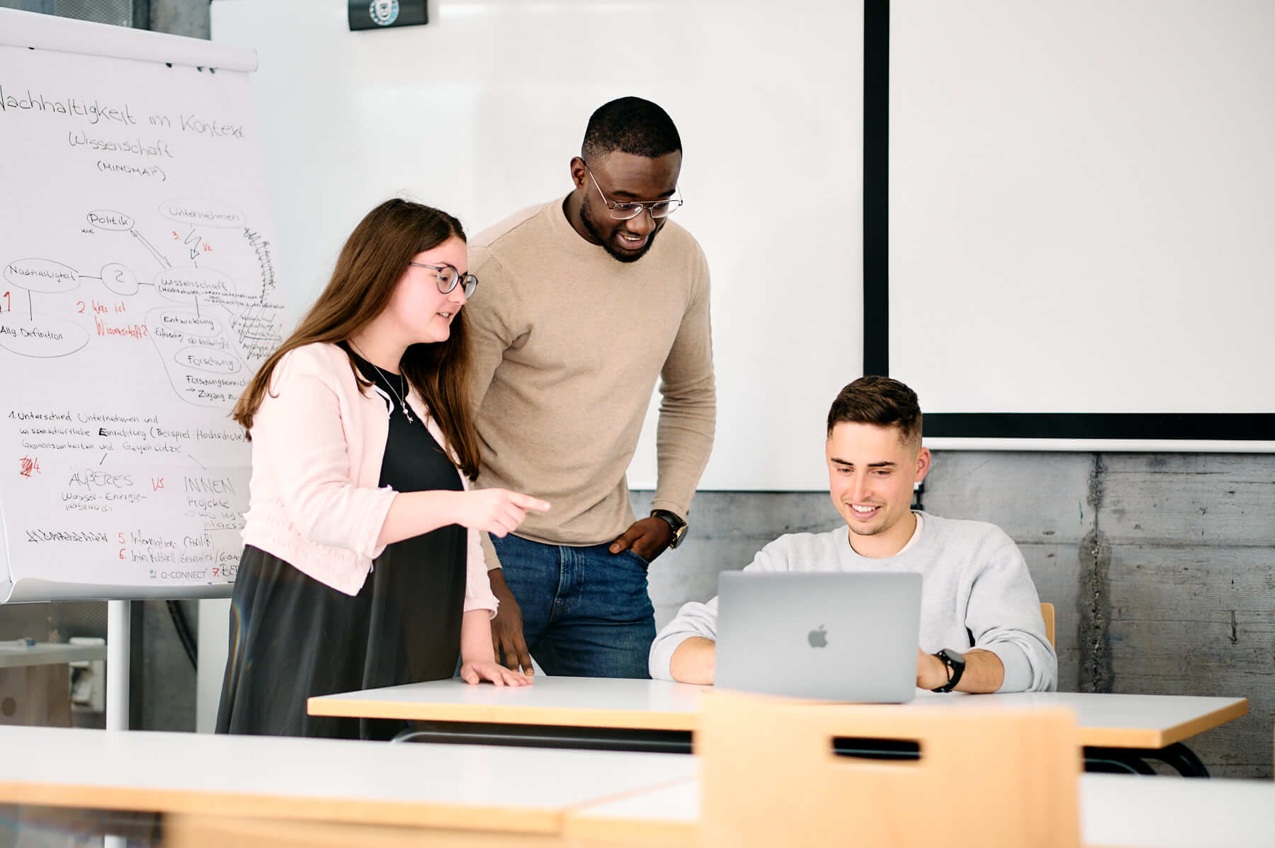 Students at the ESB Business School chatting in a lecture room.