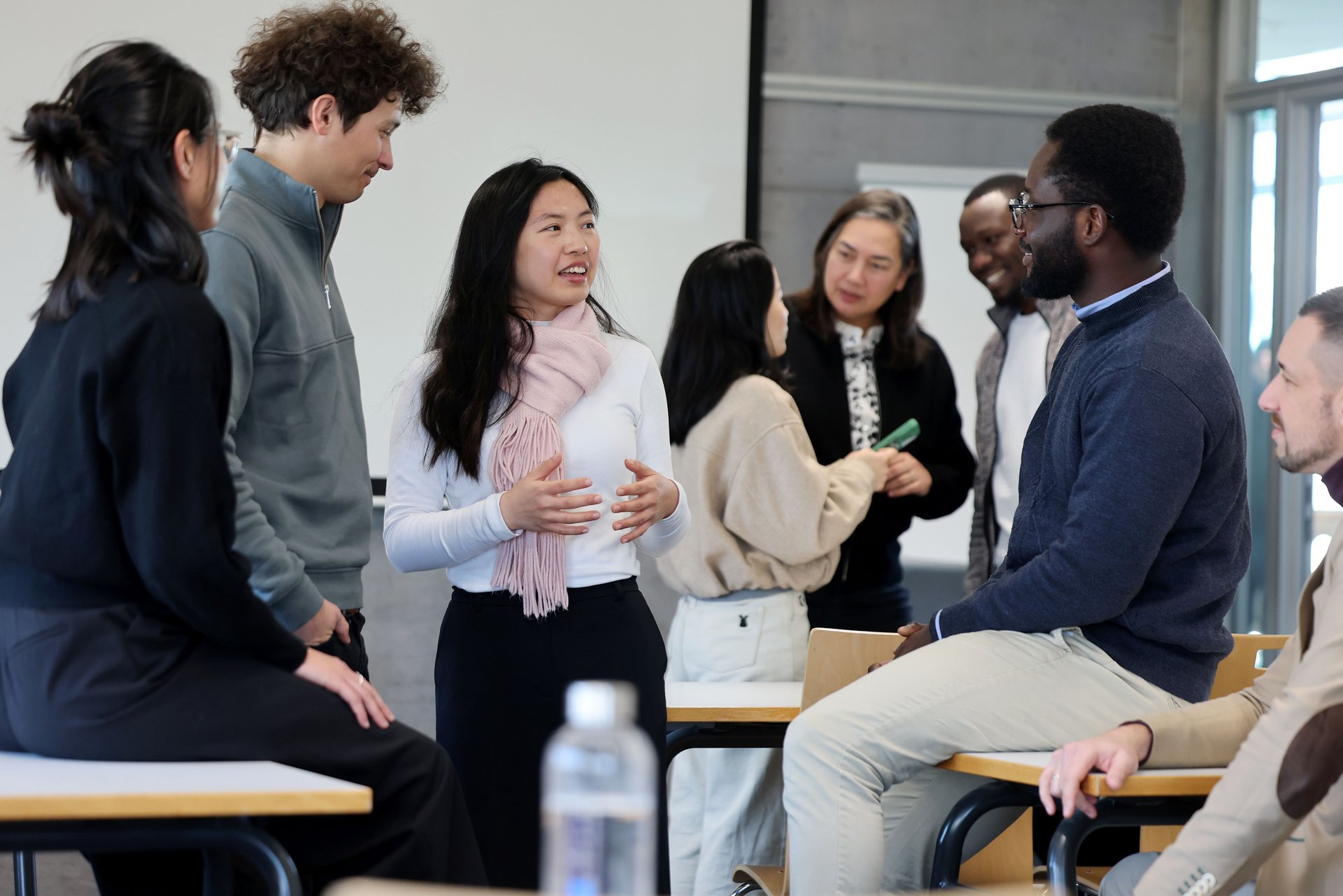 MBA students talking to each other in a classroom