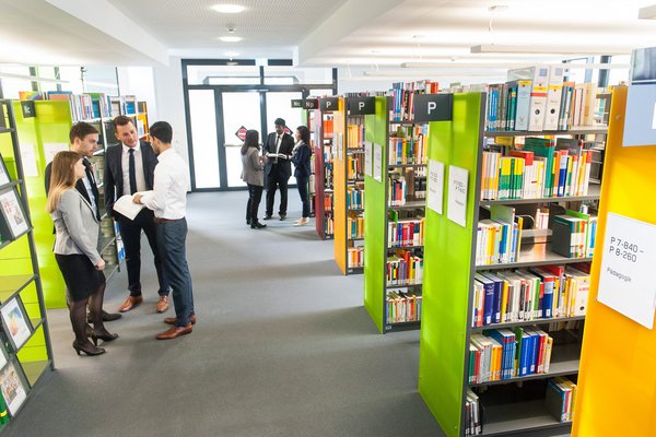 International Management double Degree ESB Business School students interacting with each other in the library.